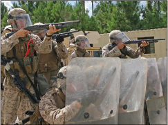 U.S. Marines Firing Non-Lethal Munitions during a Crowd Control Demonstration